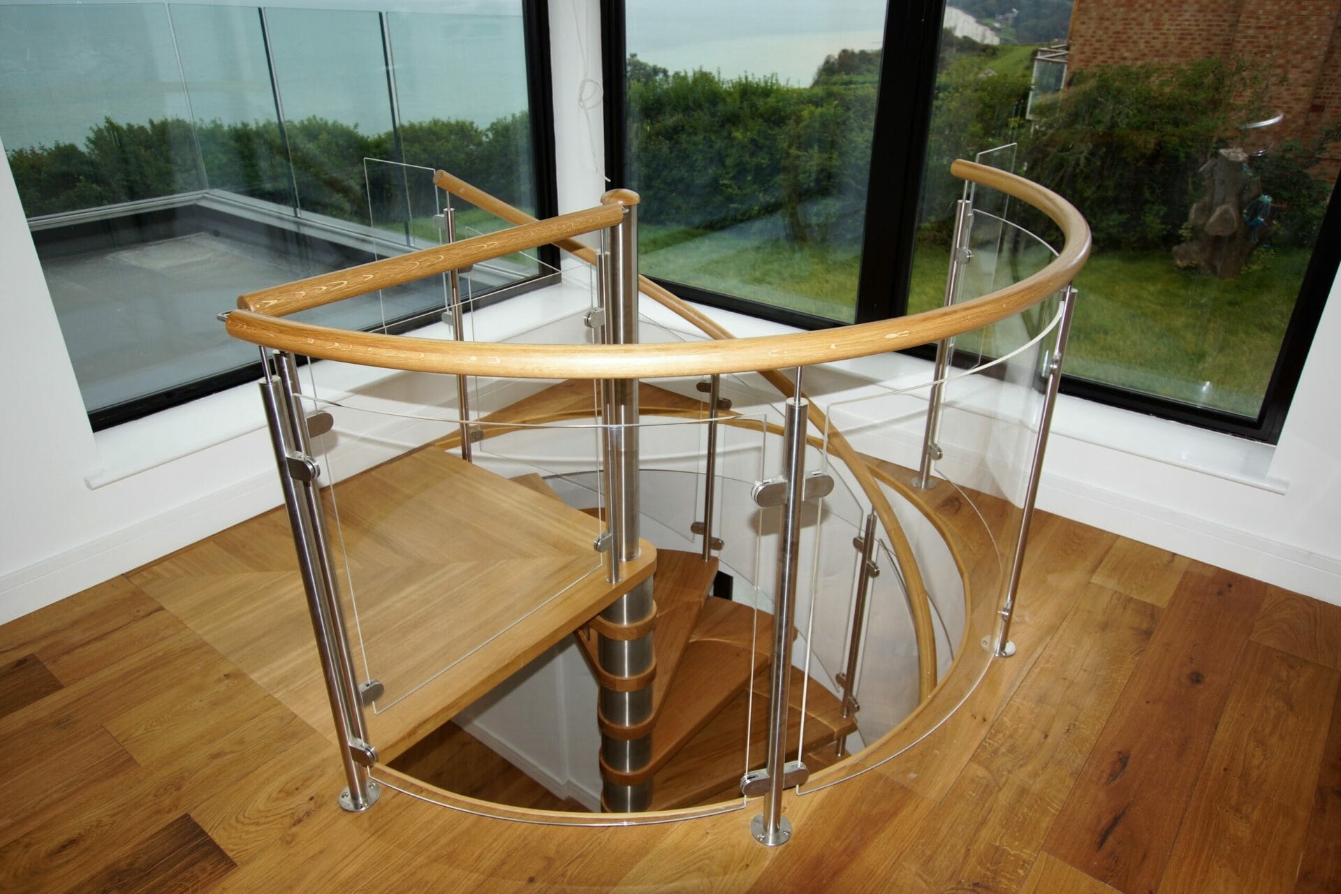 Oak Spiral Staircase with Curved Glass Balustrade